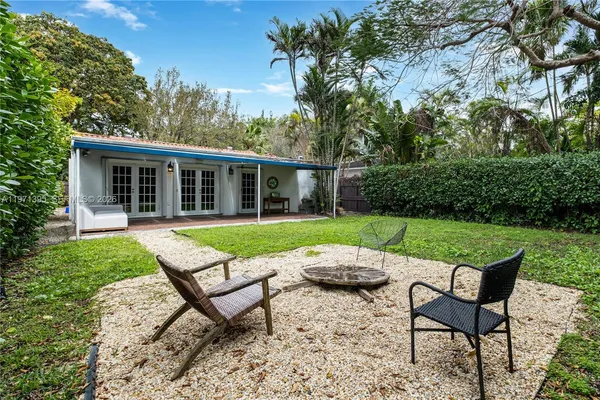 a view of a house with a backyard and a patio