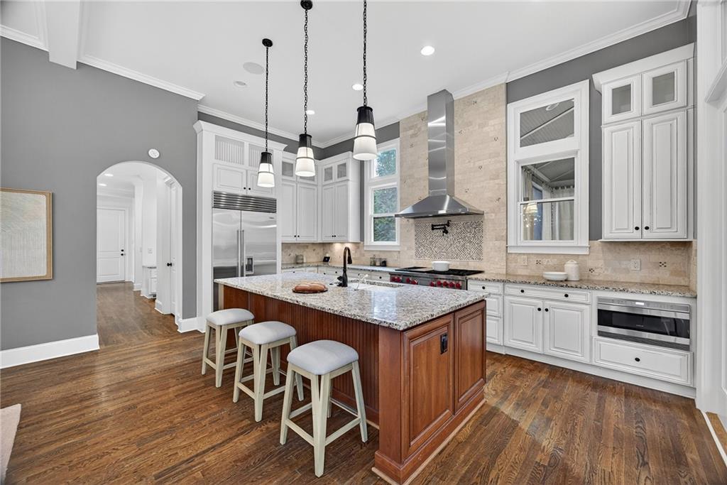 3640 Rivers Call Boulevard Atlanta, GA 30339 - Photo 11 of 63 a kitchen with stainless steel appliances granite countertop a sink a stove a refrigerator and island with wooden floor