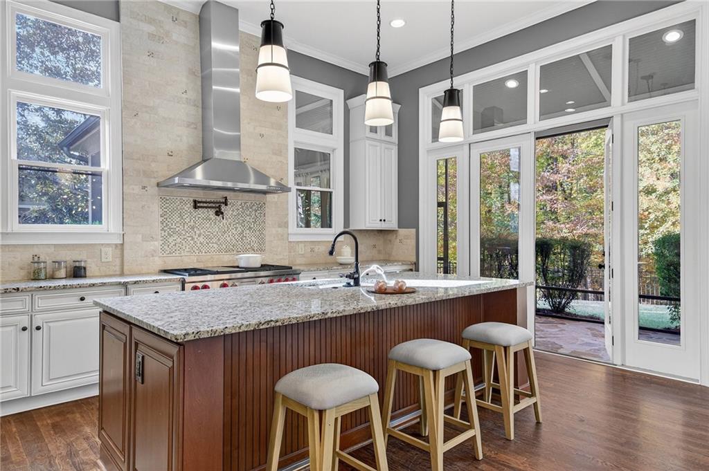 3640 Rivers Call Boulevard Atlanta, GA 30339 - Photo 12 of 63 a kitchen with a stove a sink a dining table and chairs