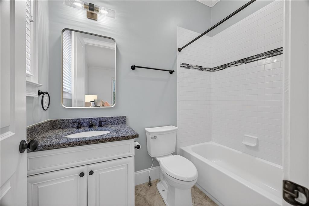 3640 Rivers Call Boulevard Atlanta, GA 30339 - Photo 31 of 63 a bathroom with a granite countertop sink mirror vanity and toilet