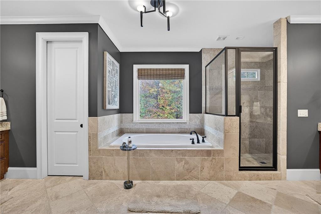 3640 Rivers Call Boulevard Atlanta, GA 30339 - Photo 35 of 63 a bathroom with a tub a sink and a large mirror