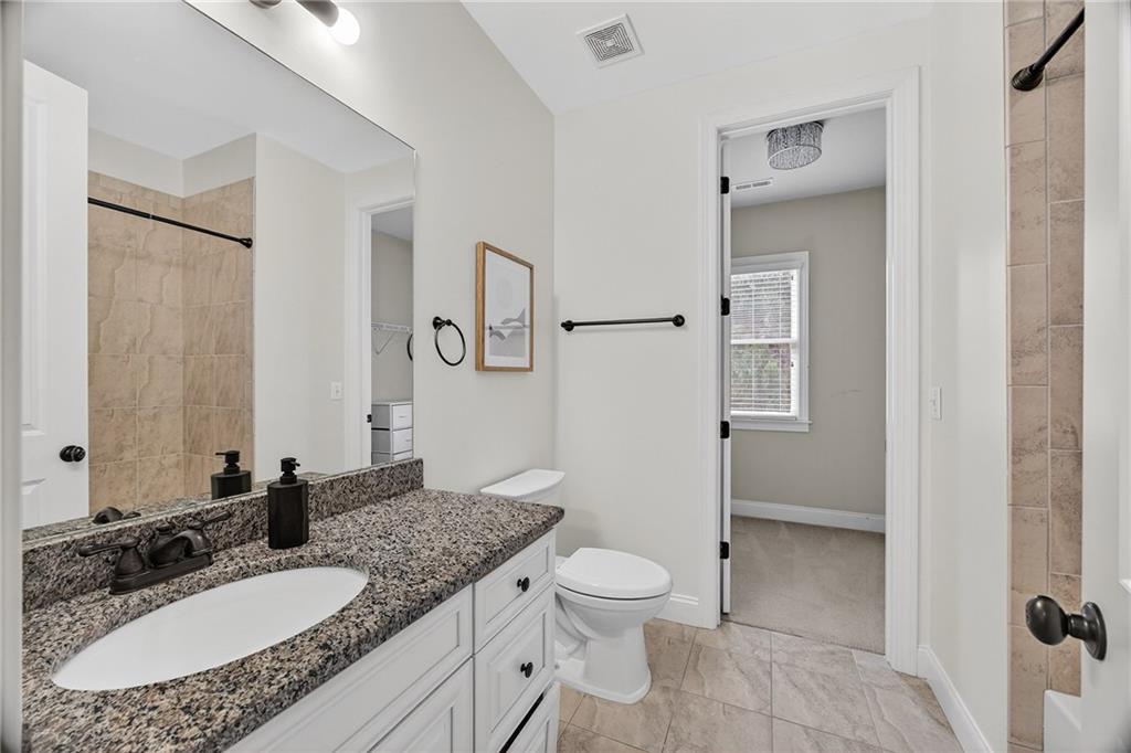 3640 Rivers Call Boulevard Atlanta, GA 30339 - Photo 39 of 63 a bathroom with a granite countertop sink toilet and shower