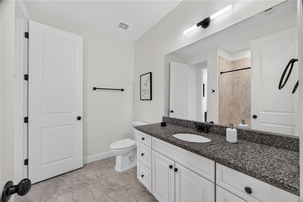 3640 Rivers Call Boulevard Atlanta, GA 30339 - Photo 43 of 63 a bathroom with double sink and a mirror