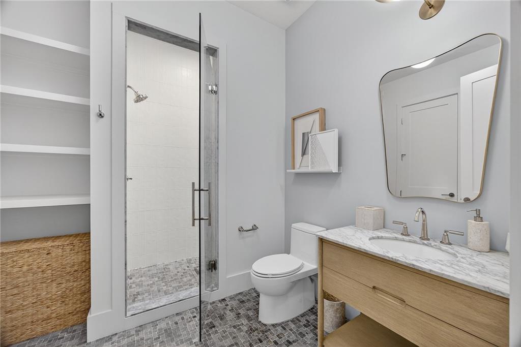 3640 Rivers Call Boulevard Atlanta, GA 30339 - Photo 54 of 63 a bathroom with a granite countertop sink toilet and shower