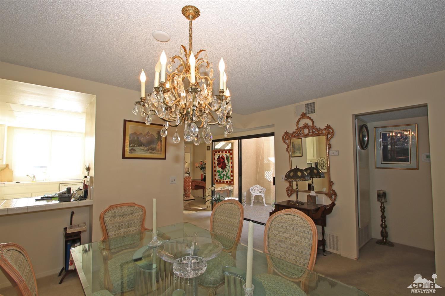 27 La Ronda Drive Rancho Mirage, CA 92270 - Photo 14 of 30 a dining room with furniture a chandelier and window
