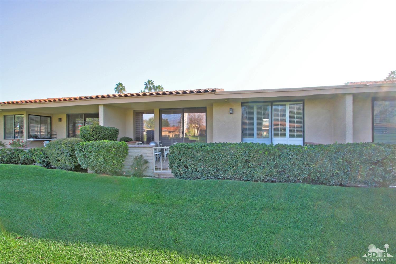 27 La Ronda Drive Rancho Mirage, CA 92270 - Photo 3 of 30 a front view of house with yard and green space