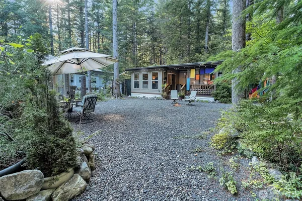 a view of a patio with furniture and table under an umbrella