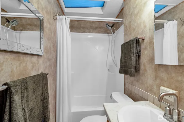 a bathroom with a shower and a sink
