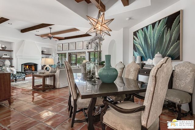 a view of a dining room with furniture and a chandelier