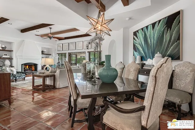 a view of a dining room with furniture and a chandelier