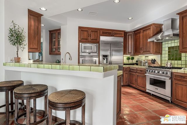 a kitchen with a stove a sink and a refrigerator