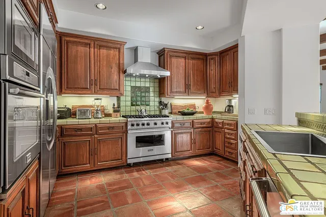 a living room with furniture a fireplace and a chandelier