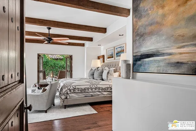 a bedroom with a bed and a large window with balcony view