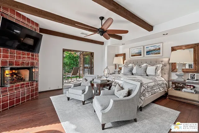 a living room with furniture a flat screen tv and a table