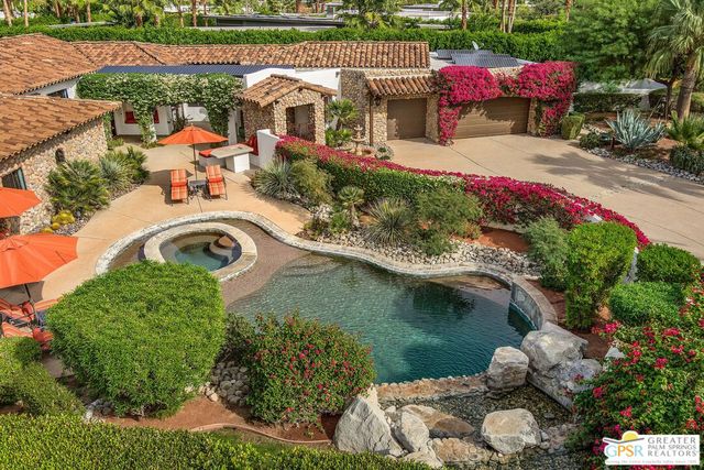 an aerial view of a house with a yard basket ball court and outdoor seating