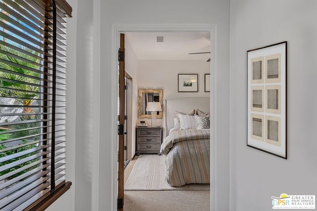 a bedroom with a bed and a flat tv screen