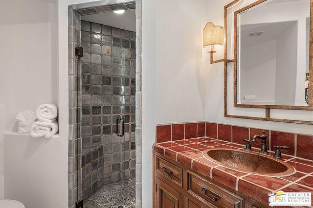 an outdoor sitting area with furniture and umbrella