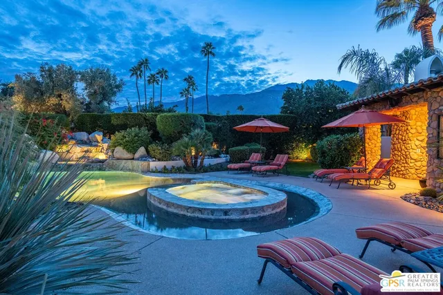 a view of a swimming pool with a patio and a yard