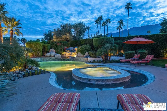a living room with lots of furniture and a chandelier