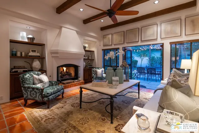 a living room with furniture a fireplace and a table
