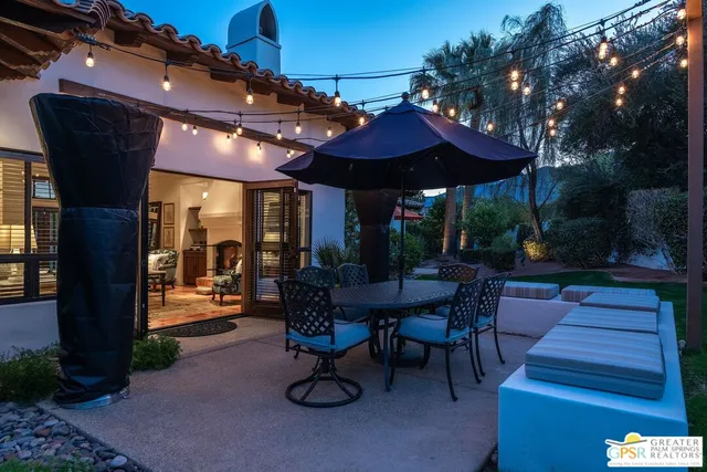 a view of a house with a yard and potted plants