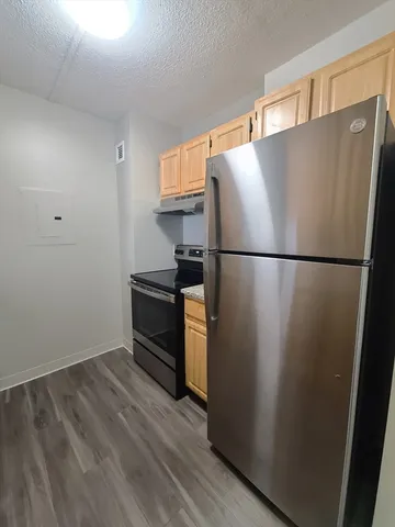 a white refrigerator freezer sitting in a kitchen