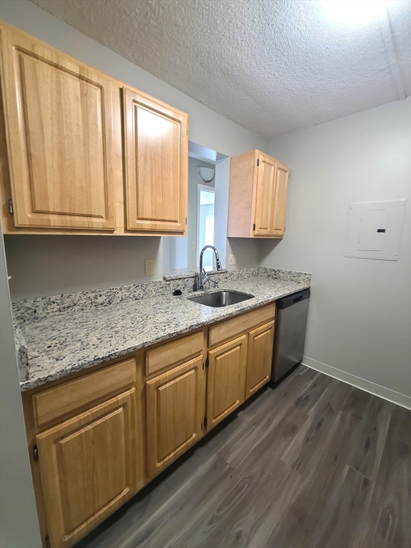 40 Westwind Road, Unit 657 Boston, MA 02125 - Photo 3 of 12 a kitchen with granite countertop cabinets stainless steel appliances a sink and a window