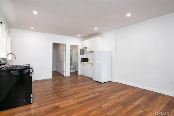 a view of a kitchen with a sink a refrigerator and window