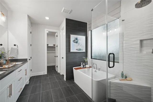 a bathroom with a tub sink and mirror