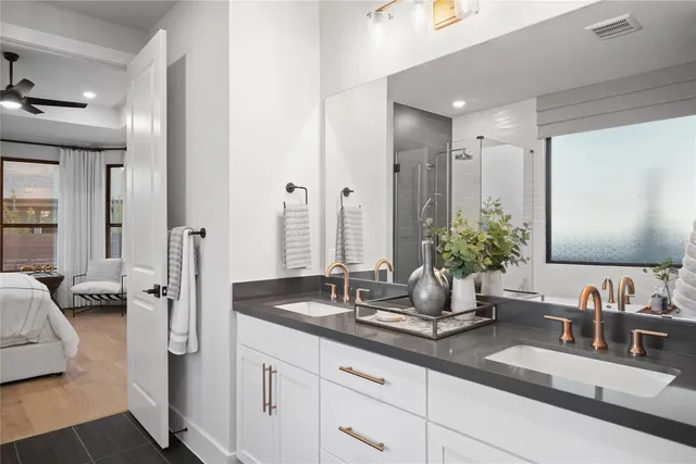 a bathroom with double vanity sinks and a mirror