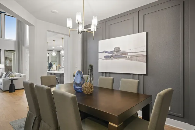 a view of a dining room with furniture and a chandelier