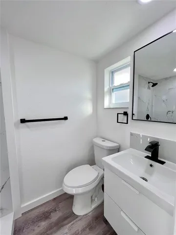a white toilet sitting next to a bathroom sink