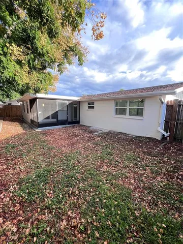 a view of a house with a backyard