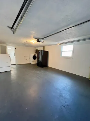 a view of a livingroom with an empty space and a window