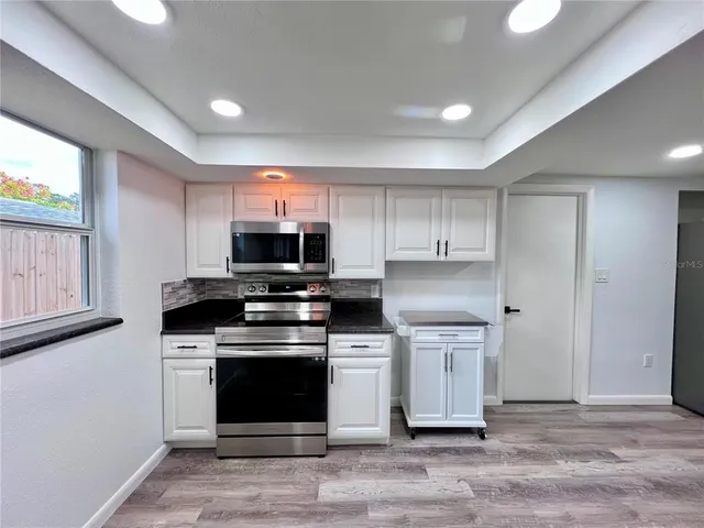 a kitchen with stainless steel appliances granite countertop a stove and a refrigerator