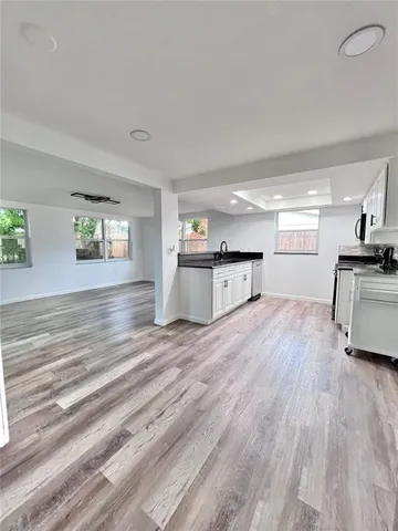 a view of a kitchen with a sink a refrigerator and window