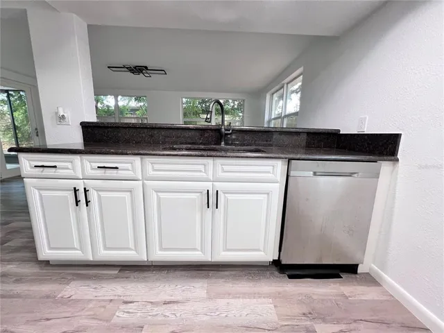 a view of a kitchen with a sink and a window