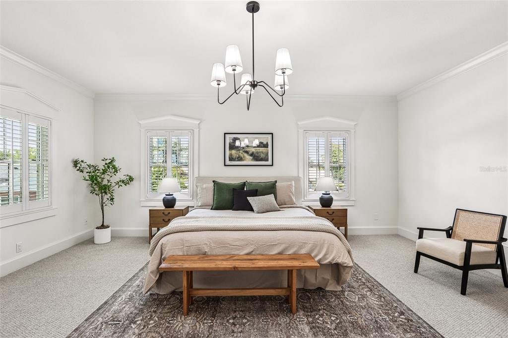 1012 Morfield Lane Brandon, FL 33511 - Photo 47 of 100 a bedroom with a bed chandelier and a window