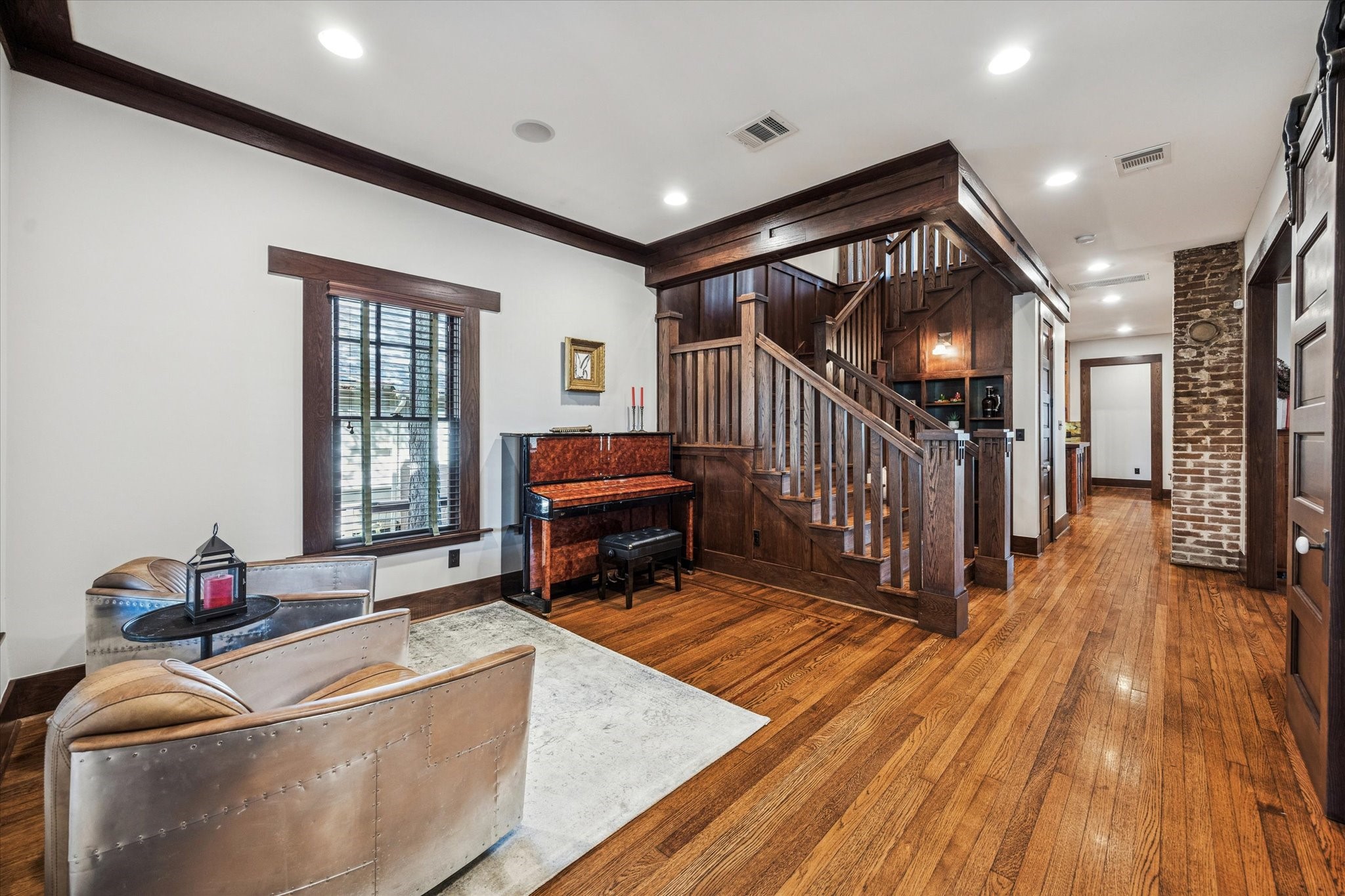 512 Archer Street Houston, TX 77009 - Photo 18 of 40 Upon entering the home you will be captivated by the impressive millwork, original brick chimney that as preserved to provide an accent wall and hardwood floors.