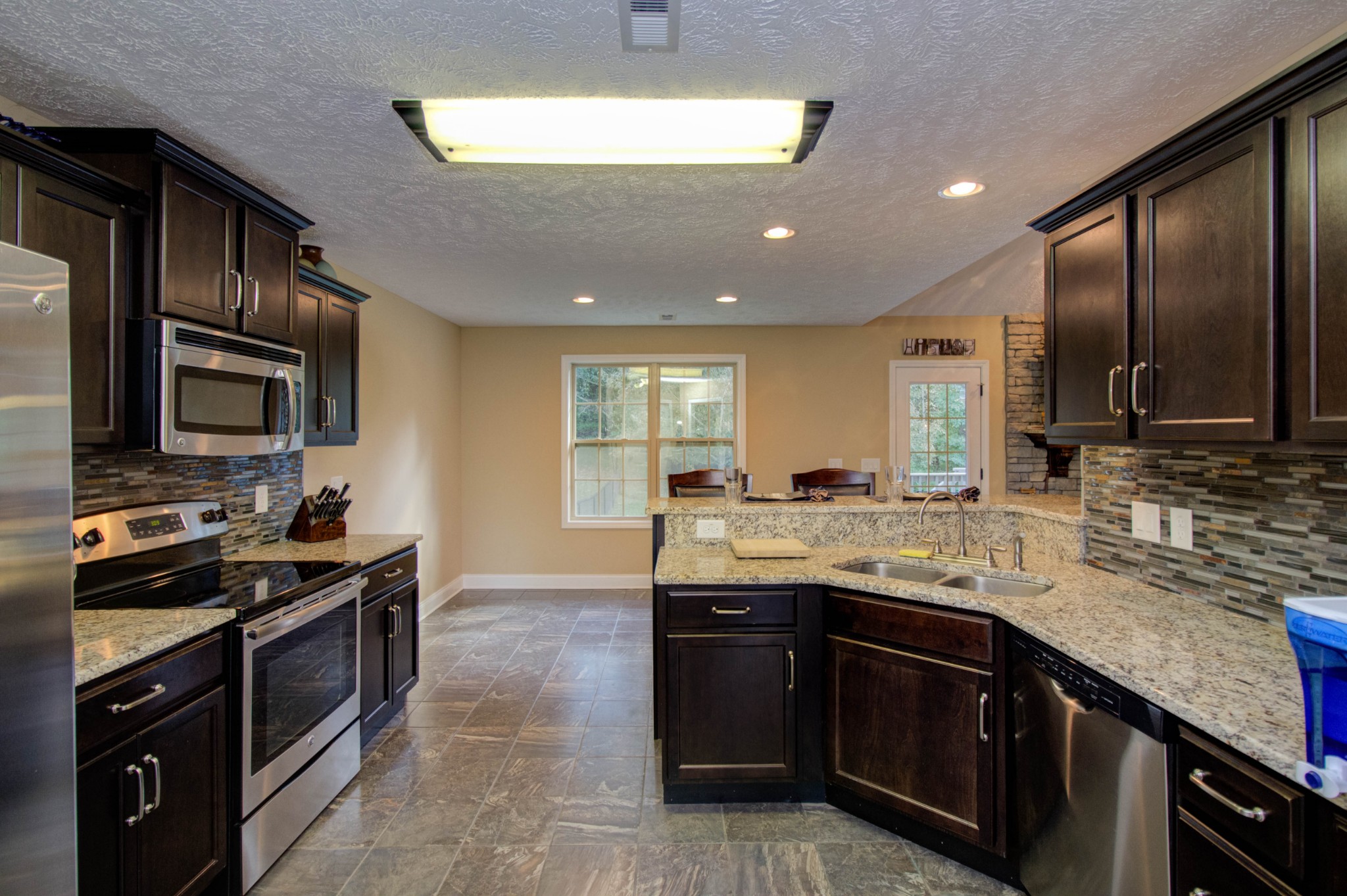 4190 Trough Springs Road Adams, TN 37010 - Photo 14 of 50 a kitchen with a sink stove and microwave