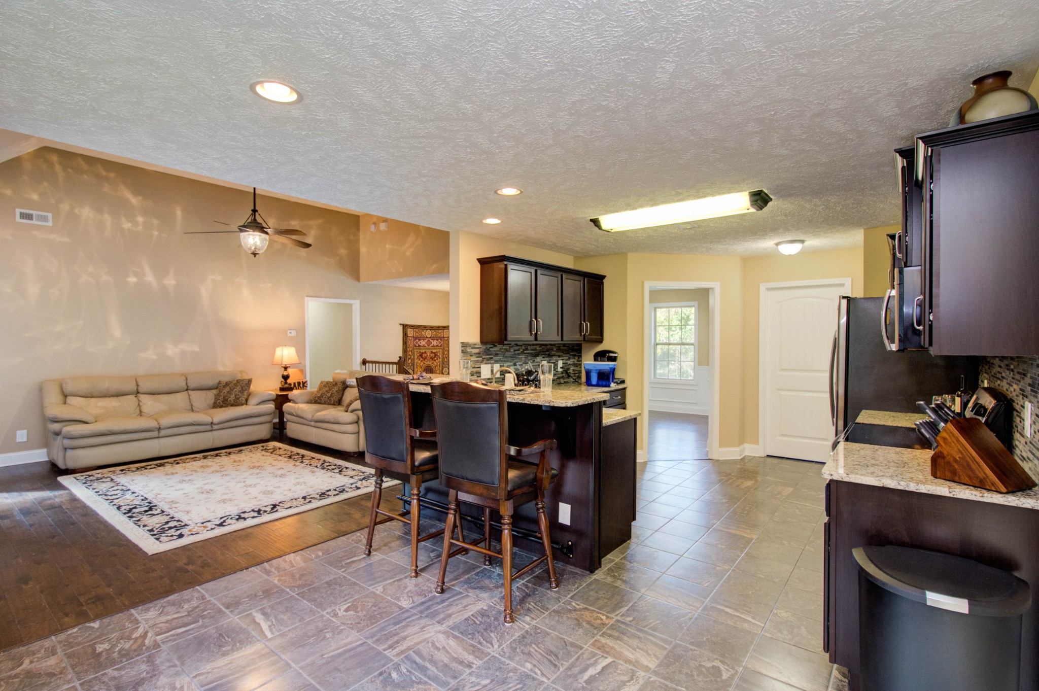 4190 Trough Springs Road Adams, TN 37010 - Photo 18 of 50 a living room with furniture a dining table and kitchen view