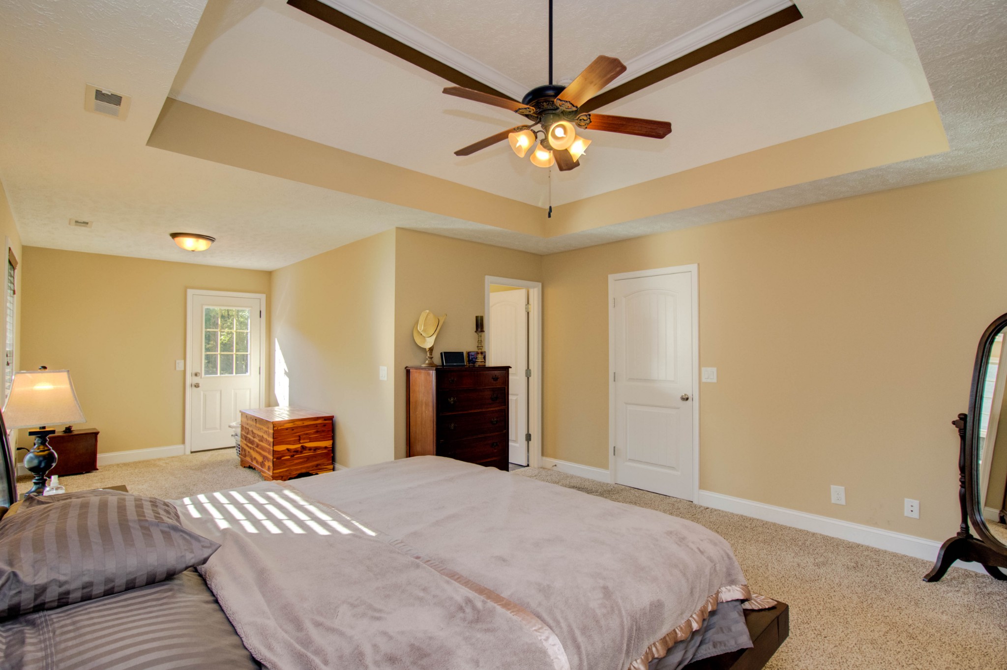 4190 Trough Springs Road Adams, TN 37010 - Photo 23 of 50 a bedroom with a large bed and a chandelier