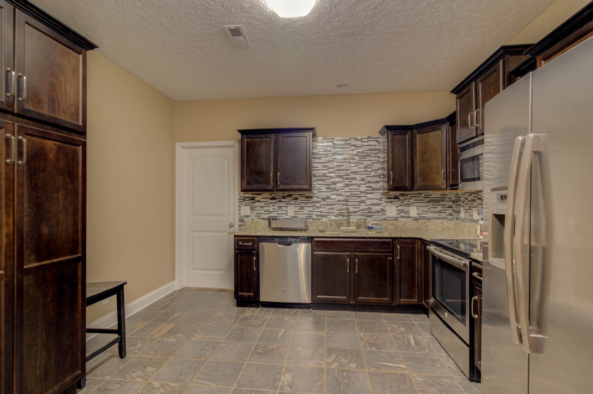 4190 Trough Springs Road Adams, TN 37010 - Photo 35 of 50 a kitchen with stainless steel appliances granite countertop a refrigerator and a stove top oven