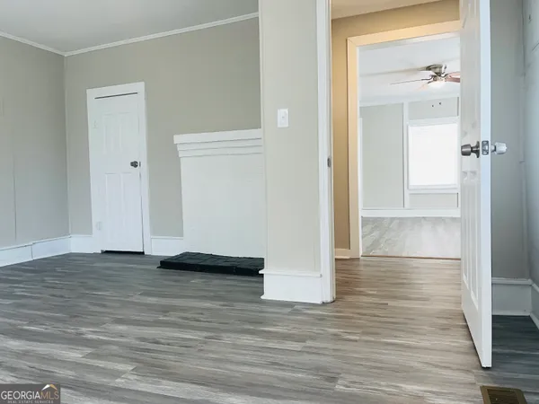 a view of empty room with wooden floor