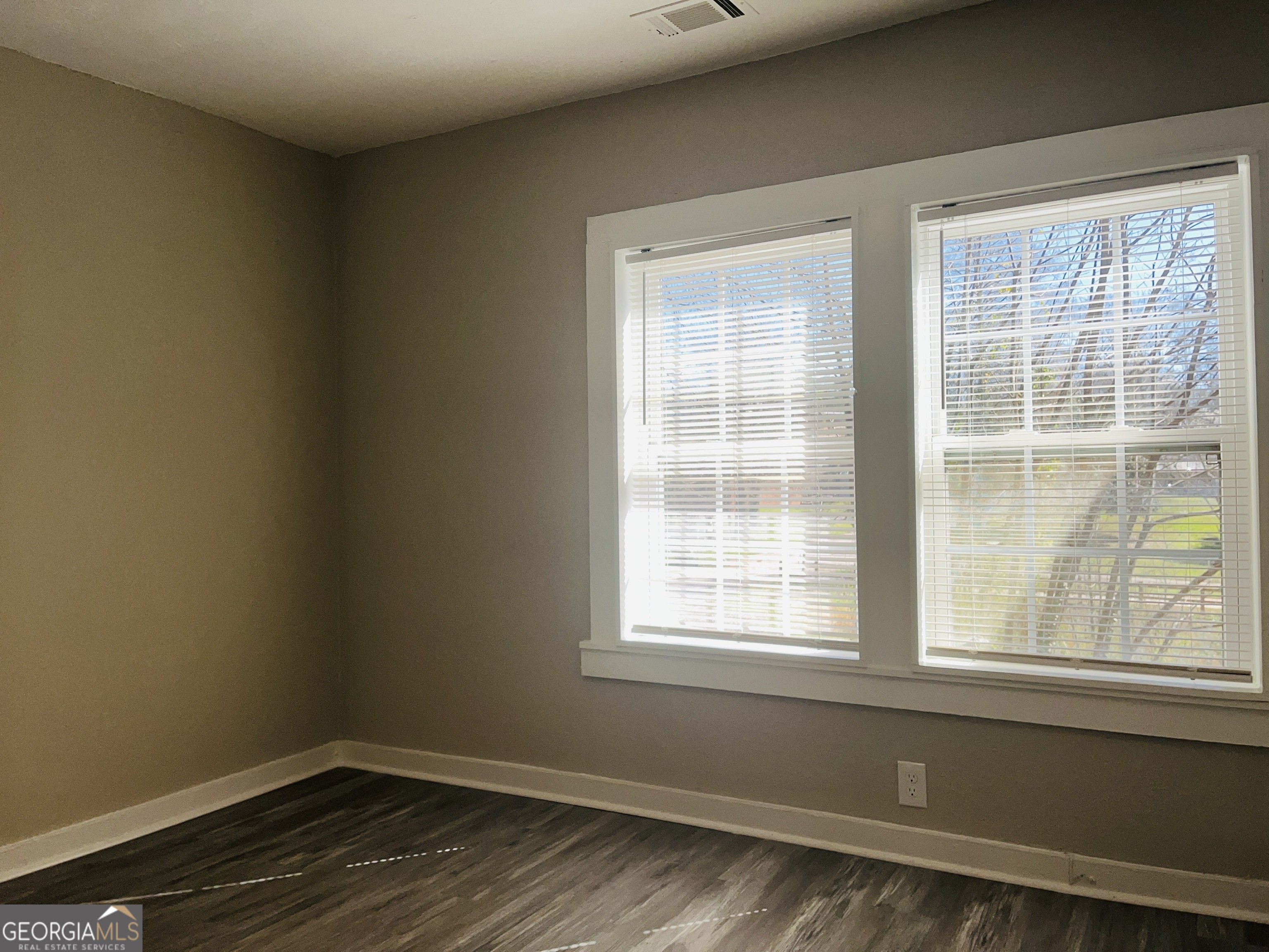 1318 Forrest Avenue LaGrange, GA 30240 - Photo 17 of 23 an empty room with wooden floor and windows