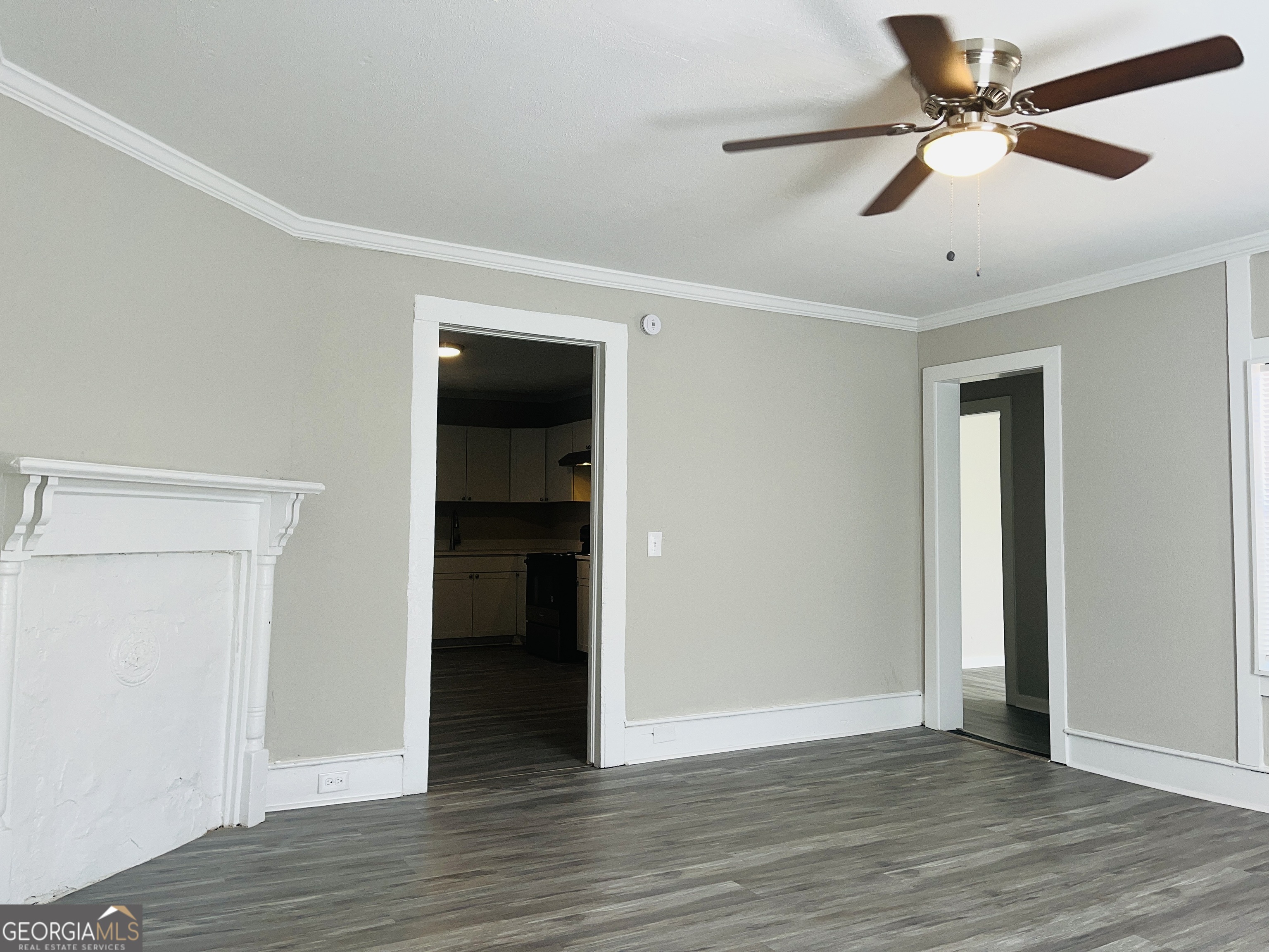 1318 Forrest Avenue LaGrange, GA 30240 - Photo 5 of 23 an empty room with wooden floor and ceiling fan
