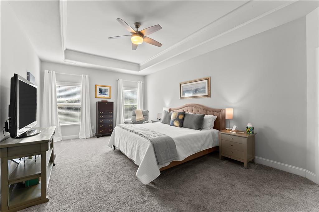 527 Gadwall Circle Jefferson, GA 30549 - Photo 14 of 42 a spacious bedroom with a bed and a flat screen tv