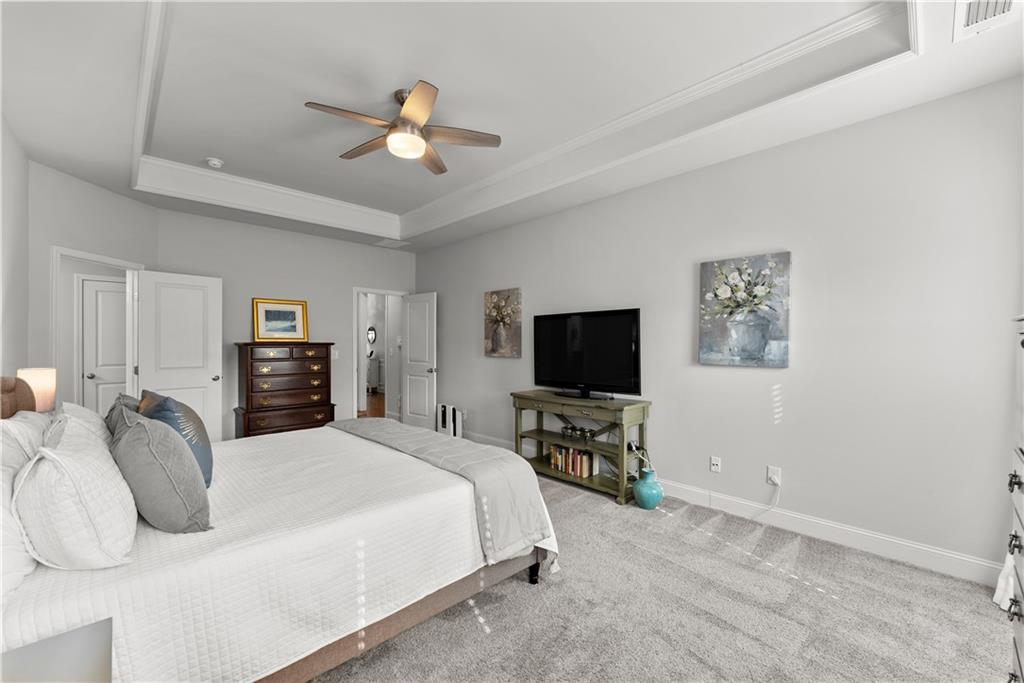 527 Gadwall Circle Jefferson, GA 30549 - Photo 16 of 42 a bedroom with a bed and a flat screen tv