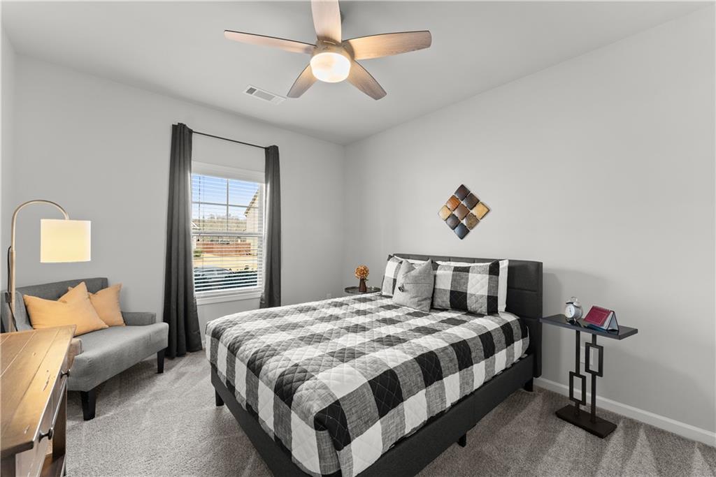 527 Gadwall Circle Jefferson, GA 30549 - Photo 23 of 42 a bedroom with a bed and a chandelier