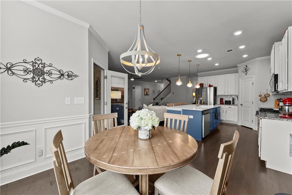 527 Gadwall Circle Jefferson, GA 30549 - Photo 10 of 42 a dining room with furniture a chandelier and wooden floor